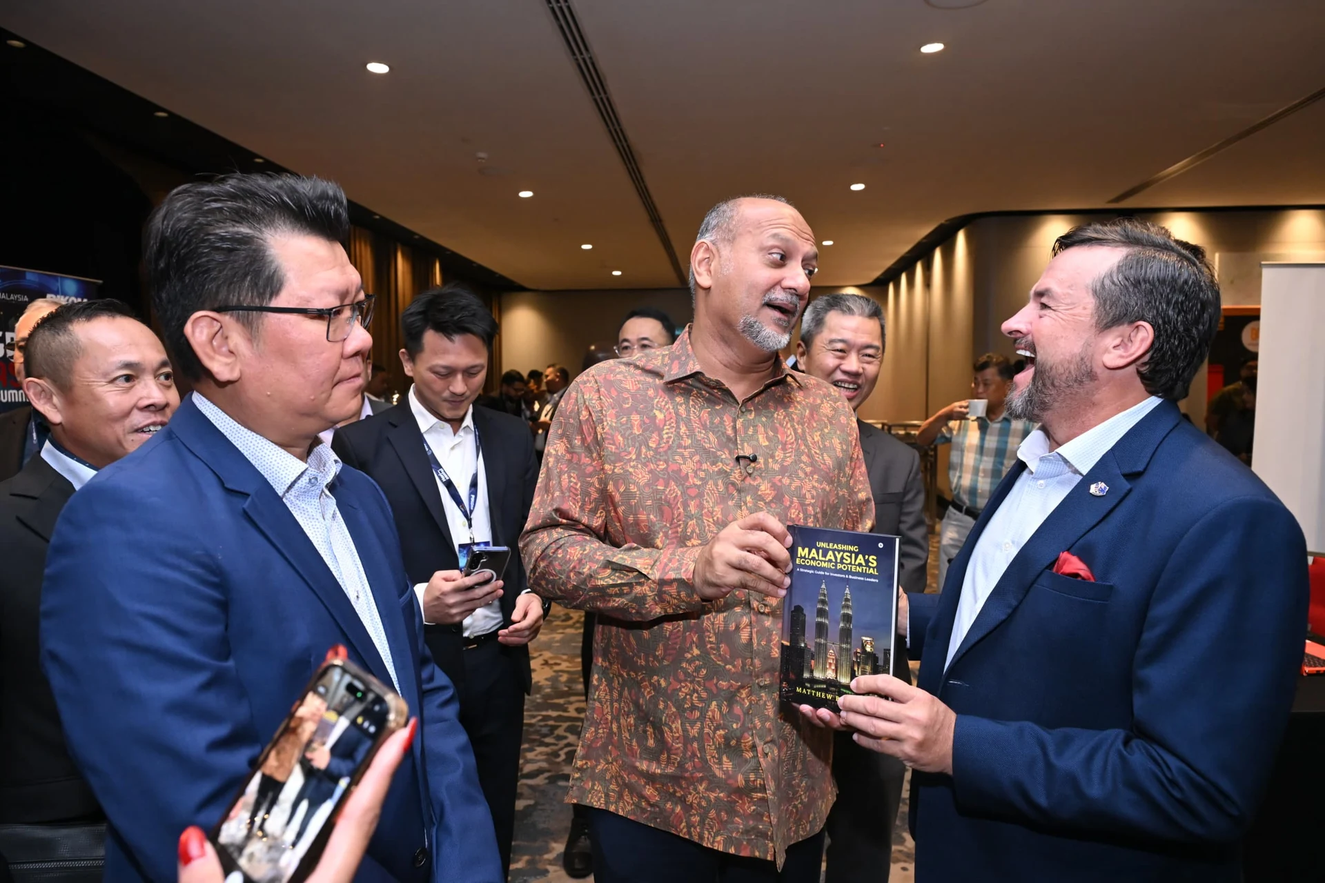 Matthew Barsing sharing his book with Malaysia’s Digital Minister